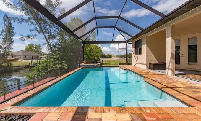 Trafalgar House | Casita Cabo Coral on Gulf Access Canal with Heated Salt Pool & Spa
