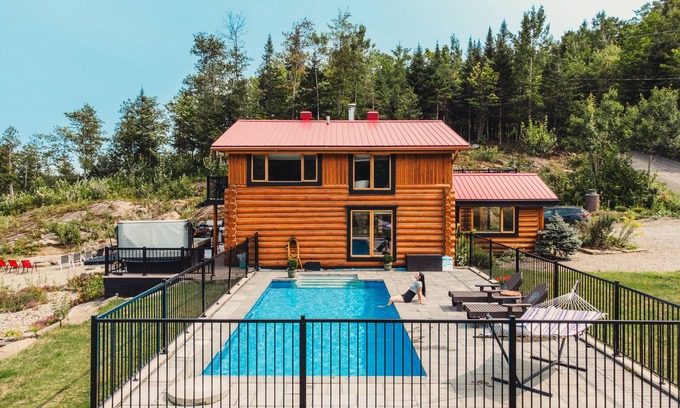 Mandeville Cabin | Charming log cabin nestled in the woods, with a spa and in-ground pool.