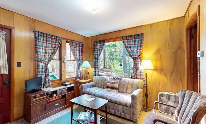 Manitowish Waters Cabin | Charming waterfront cottage with shared firepit, canoe, paddlebaot & docks