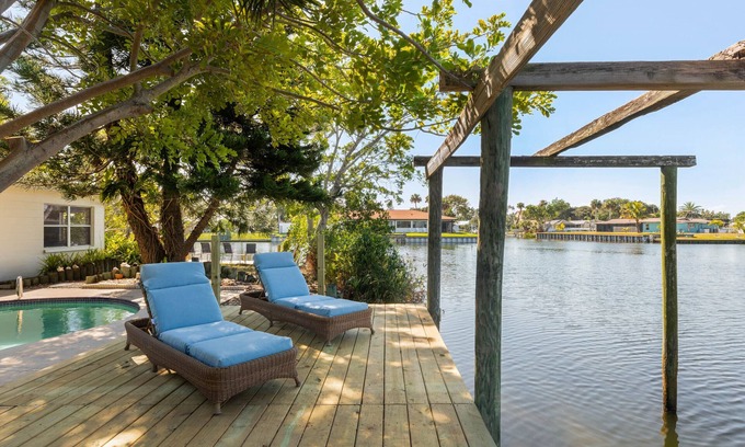 River Isles House | Coconut cove - peaceful garden retreat with HEATED pool on canal near the beach!