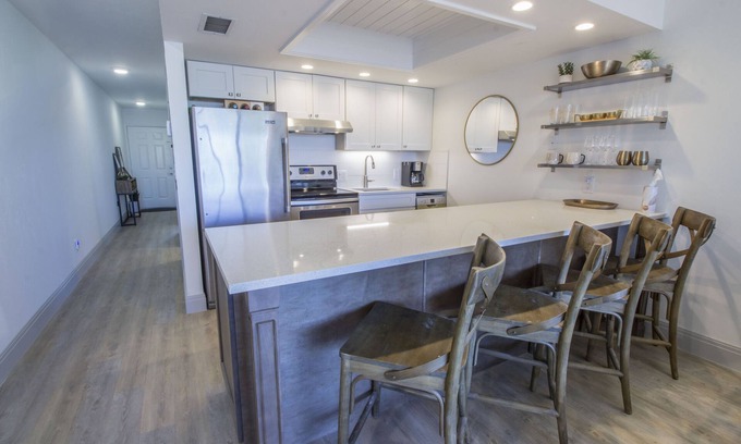 Vanderbilt Beach Condo | Designer Condo! Walk to the Beach! Bay Views! Rooftop Pool! Fully Renovated!