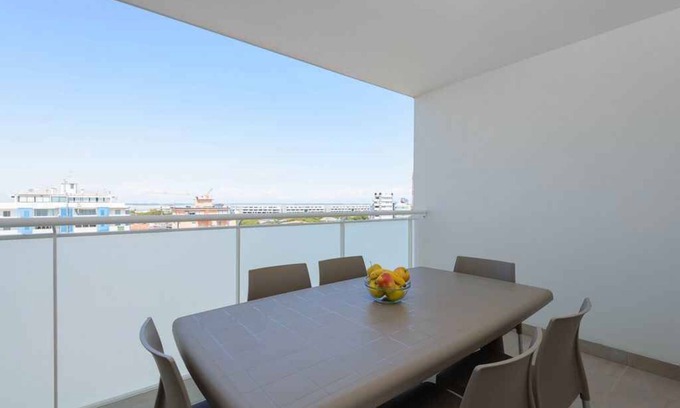 Lignano Sabbiadoro Apartment | Holiday apartment with air conditioning and balcony with lagoon view