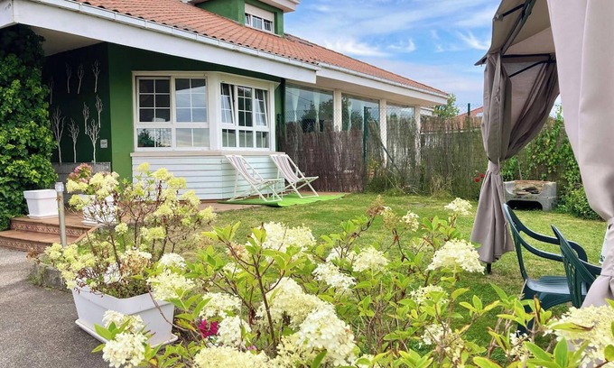 Aviles House | Homerez - Charming House in Bastian, Garden