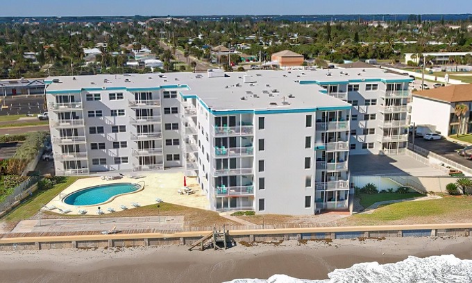 South Patrick Shores Condo | Inviting condo with ocean view, balcony, full kitchen, central AC, & W/D