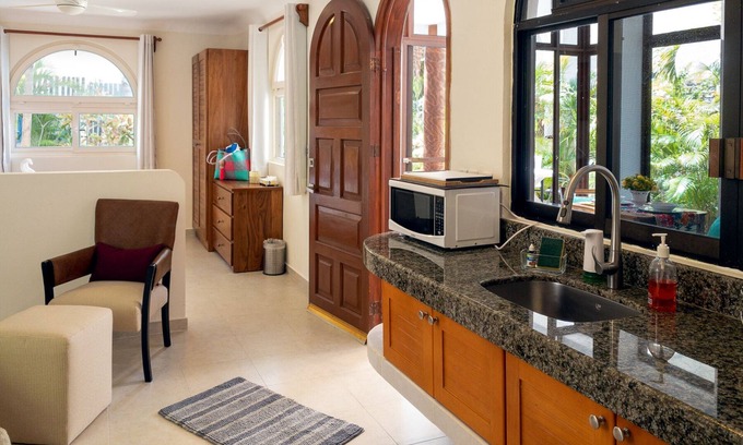 Puerto Morelos Apartment | Large studio with king bed, full kitchen, sofa bed. Half wall separating.
