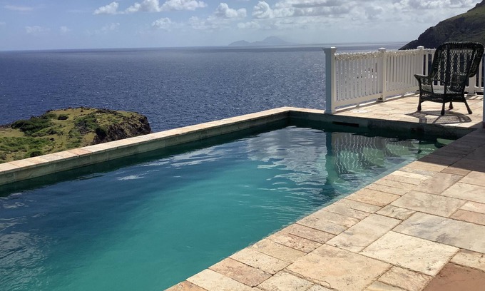 Windward Side Villa | Modern Luxury Villa in Flatlands. Pool. Walk to Beach. Sleeps 6. Ocean Views.
