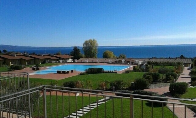 Manerba del Garda Apartment | Montecolo Resort three-room apartment with splendid lake view, swimming pool