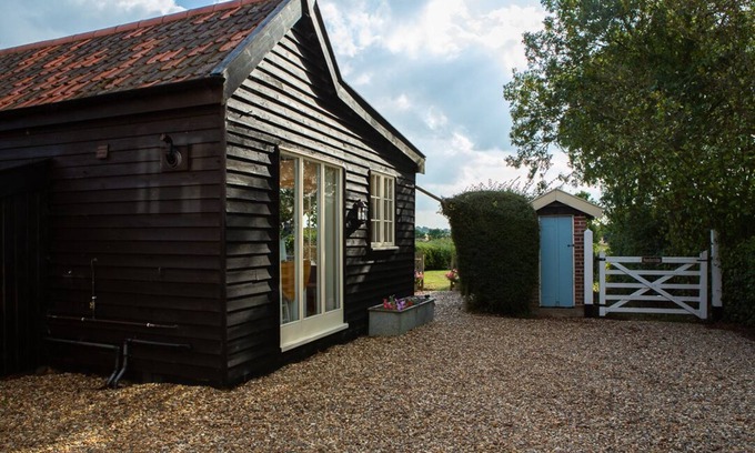 Alburgh House | One bedroom barn with open plan living area, private patio/garden,great sunsets