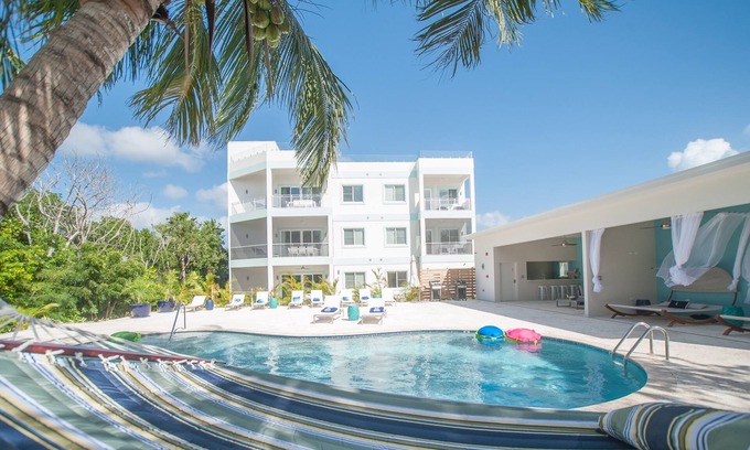 West Bay Condo | Private 7 Mile Beach Beach Club. Ocean views from Roof Terrace and Pool Pavilion