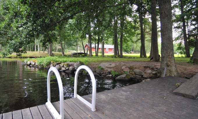 Holsbybrunn House | Red and white holiday home beautifully situated by the river Emån