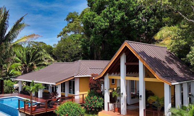 Gibson Bight House | Relax at this hillside retreat that overlooks the lush forest and the Caribbean.