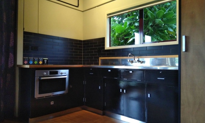 Urenui House | Relax in park-like grounds with outdoor spa.