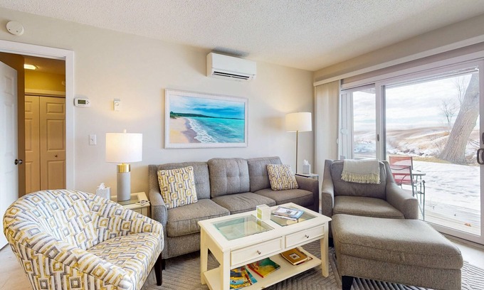 Maple City Condo | Riverview condo near the lake with beach access, fireplace, patio & cable
