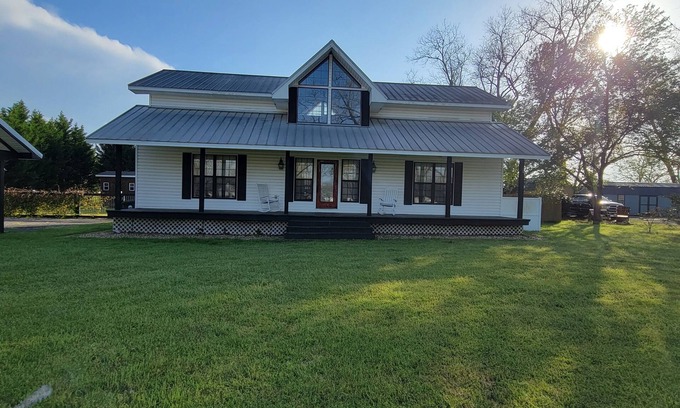 Peach County House | Rocking Chair front porch looking out on sprawling pecan trees filled w/nature.