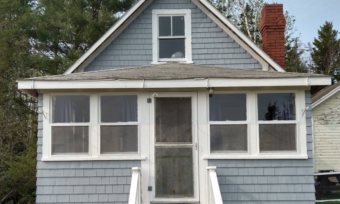 Dennysville Cottage | Rustic, two-story, clapboard cottage, field view, Pet-friendly, Downeast Maine