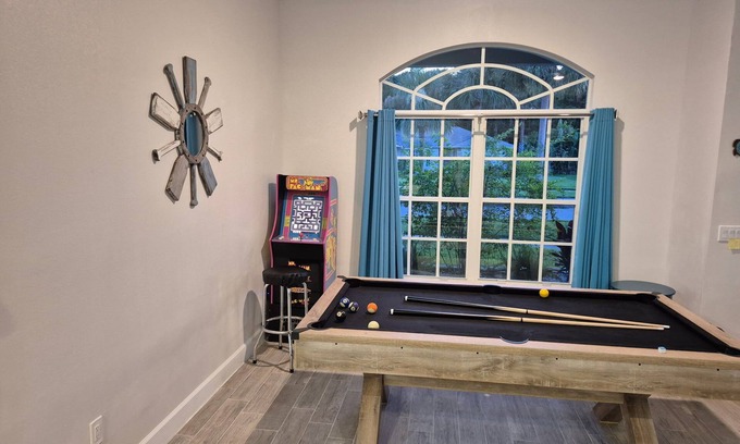 The Orchard House | Sadie's Daytona private pool home with 5 king beds , pool table and arcade games