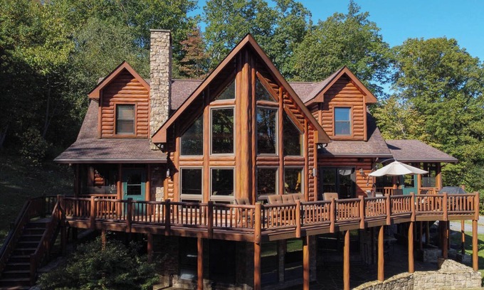 Huntly House | Secluded 4 bedroom log style home with screened porches, deck and fishing pond.