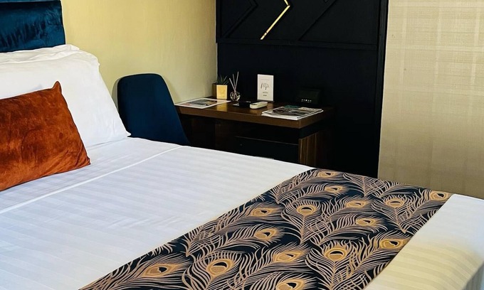 Gaborone Bed & Breakfast | Shiloh Inn-Tranquil midnight blue accent walls set relaxation tone for your stay