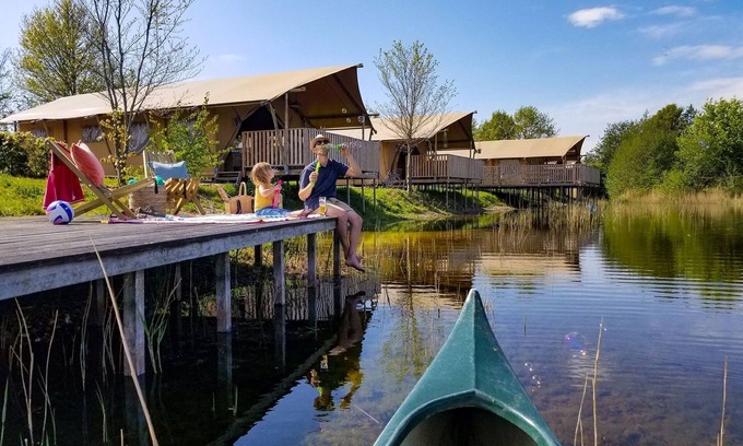 Bant House | Tents with kitchen and bathroom near a pond