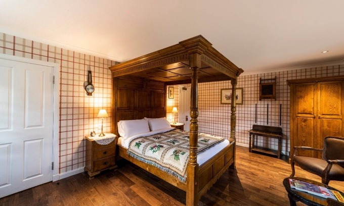 Shiel Bridge Bed & Breakfast | The wooden floors, vintage furniture, and tartan accents create a comfy room