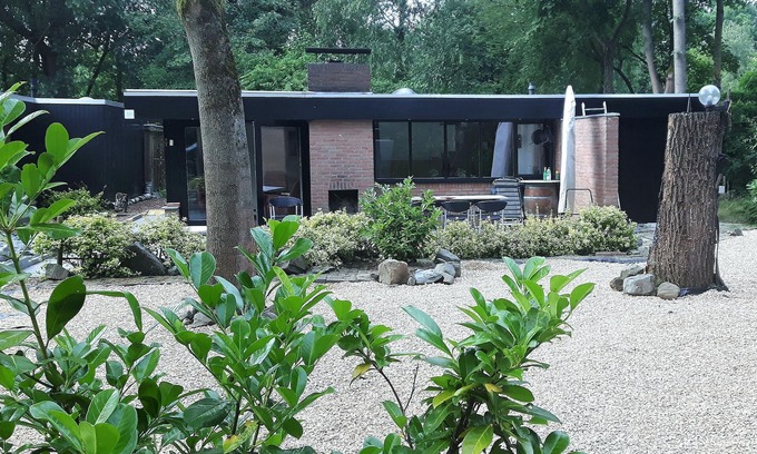 Rekem House | This beautifully situated vacation home is located in a wooded area in a welcoming vacation park nea