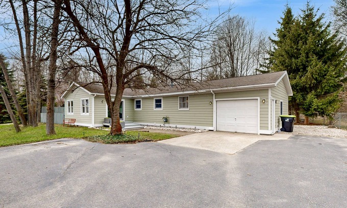 Suttons Bay House | Tranquil Lakeview Retreat in Suttons Bay, with a private sauna, & large yard