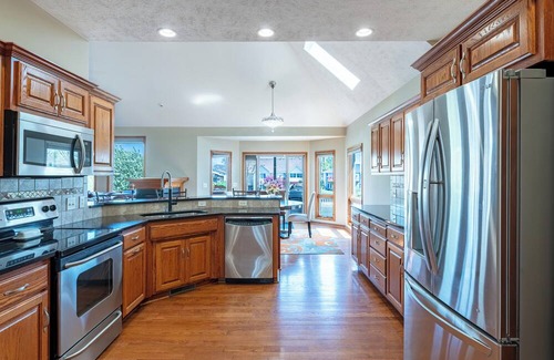 Carter Lake House | 5 bed 3 miles to downtown Omaha and CWS. Hot Tub, Pool Table & Dart Board